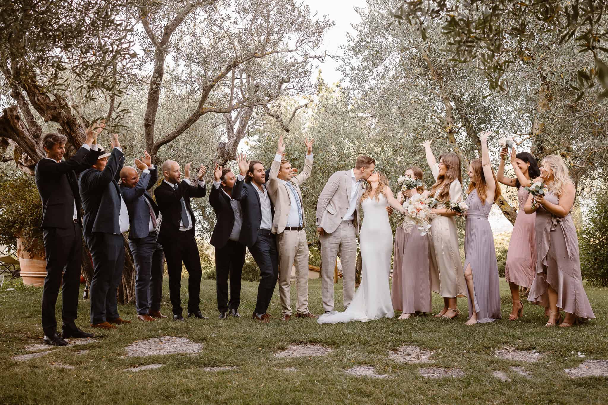 Bridal party cheering on the bride and groom at a beautiful Tuscany destination wedding