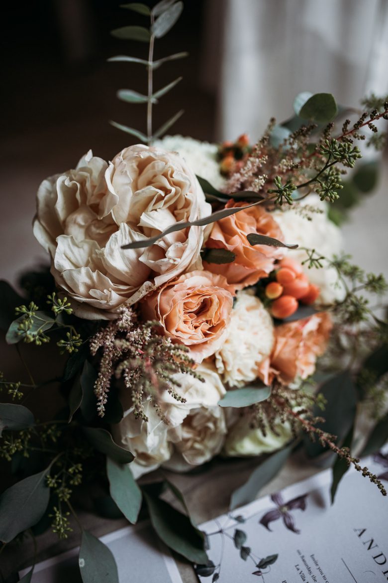 Bride bouquet with avory and peach peonies and berries at La Villa Hotel Mombaruzzo