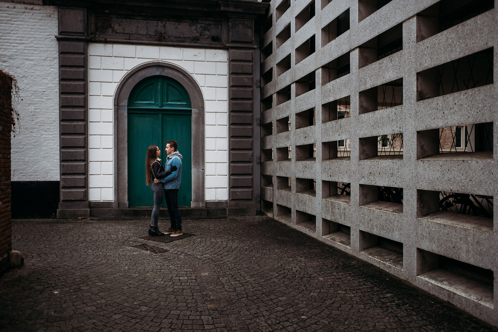 Couple on a doorstep in Bruges, Belgium